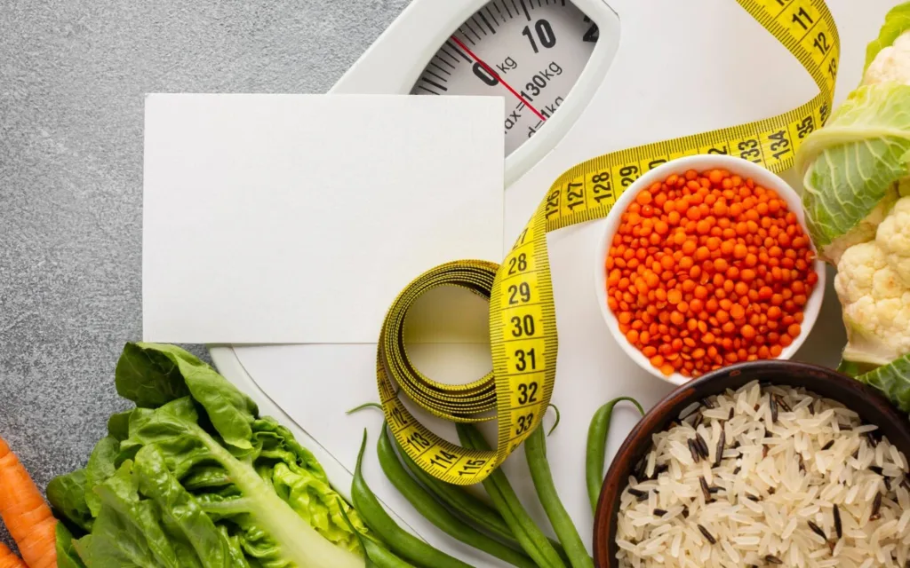 Colorful vegetables and a portion of rice balanced on a scale.