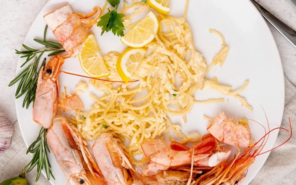 A dish of shrimp and pasta garnished with krill powder.