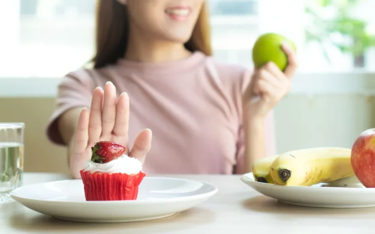 A vibrant cupcake adorned with assorted fruits and a banana