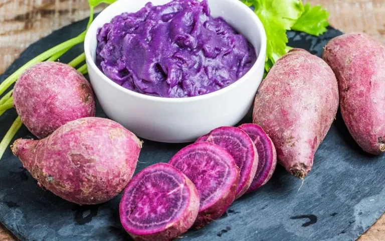 A vibrant purple beetroot alongside a bowl of beetroot paste