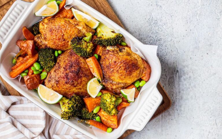 Juicy chicken thighs nestled with vibrant vegetables.