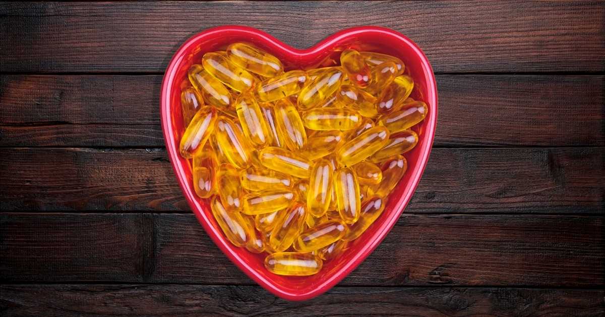 some fish oil capsules, placed on a dark wooden surface.