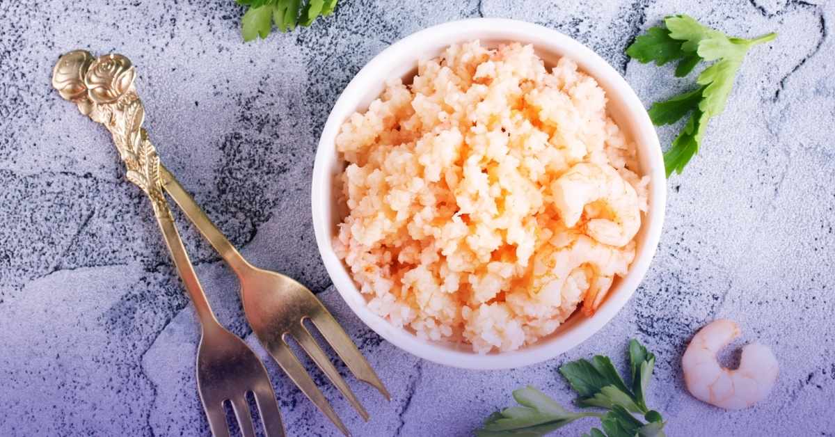 Bowl of cooked krill meat with silver forks, showcasing a nutritious high-protein krill dish.