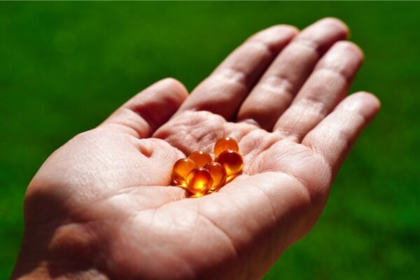 krill oil capsules in a Athletes hand.